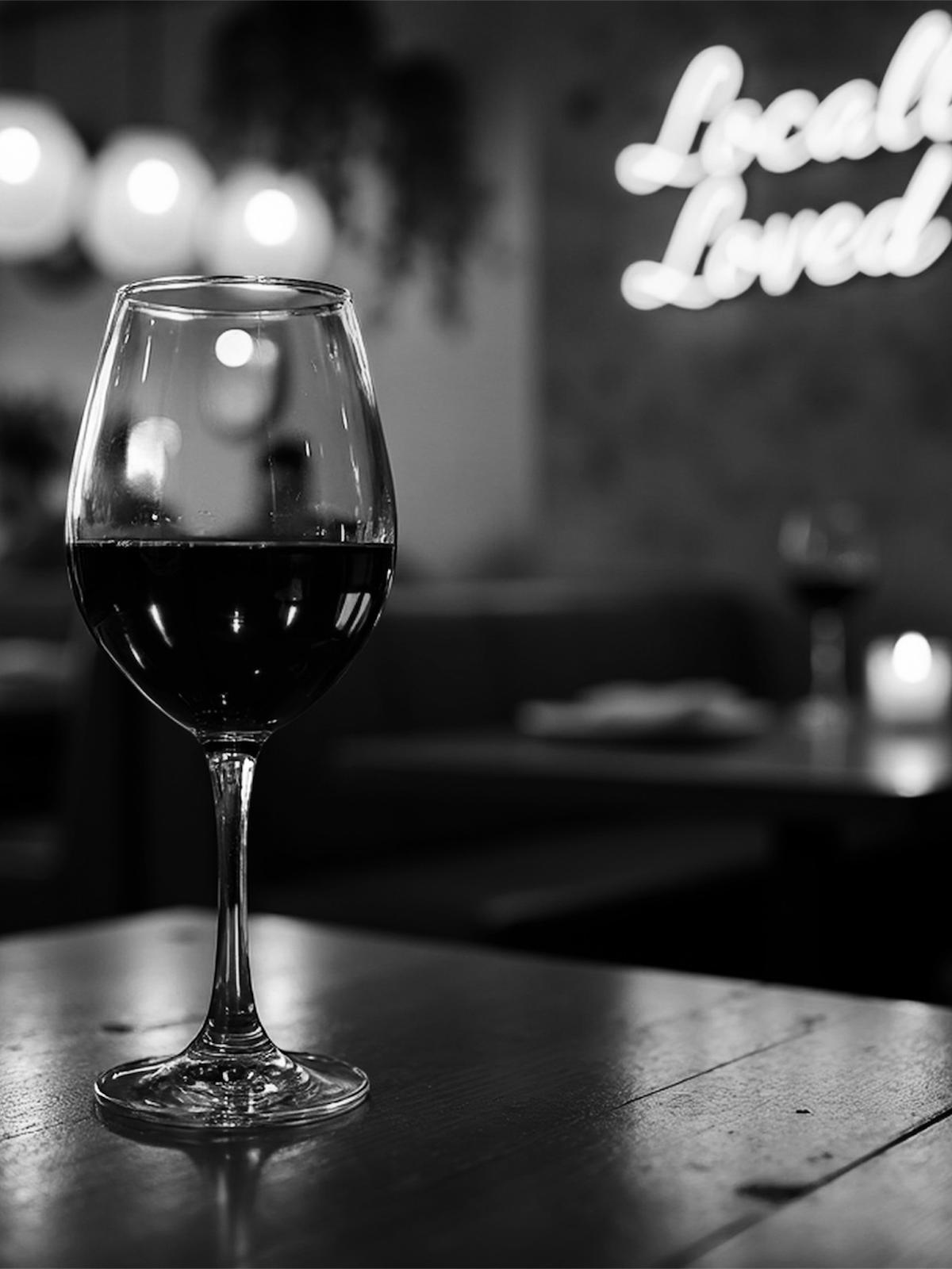 Glass of red wine, black and white